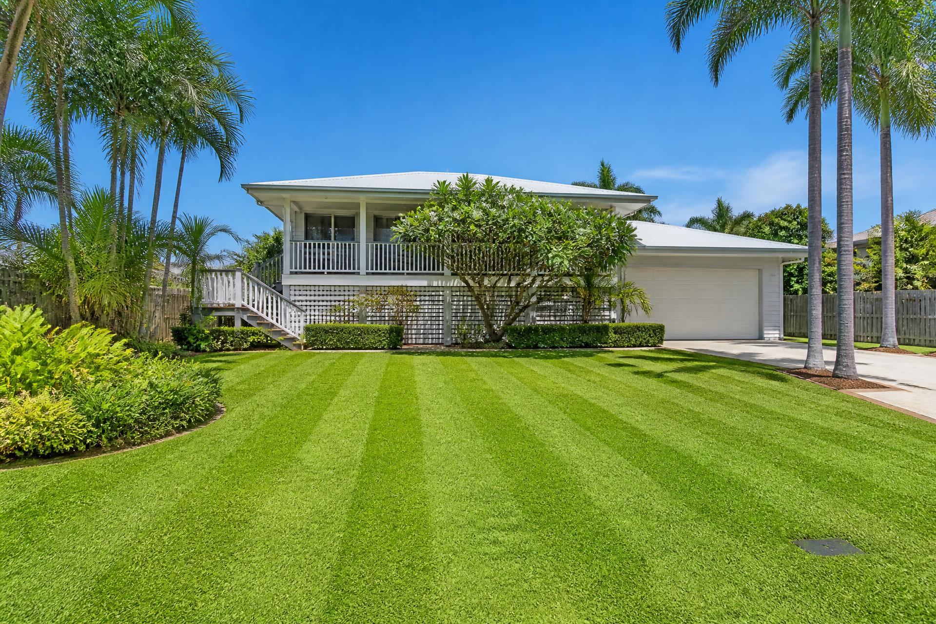 Striped freshly mown front lawn at a Townsville home on a sunny day